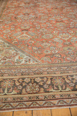 Distressed Mahal rug detail with visible wear, showcasing terra cotta tones and charcoal border.