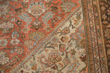Vintage Distressed Mahal carpet: faded floral vinery on terra cotta and beige fields, with border.