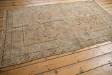 Vintage distressed Khotan rug, allover pattern, featuring sand, ivory, and soft blush tones.