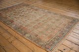 Distressed Khotan rug showcasing worn germinating plant motifs in muted beige, pale orange.