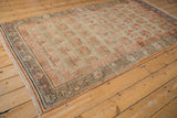 Distressed vintage Khotan rug fringe and time-worn border with pale pink plant motifs.