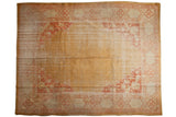 Vintage Oushak: open gold field, oversized terra cotta floral spandrels, ivory border, 10'7