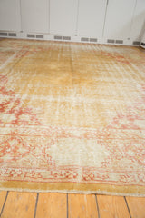 Worn gold Oushak rug border with cartouche design and intact side selvage.