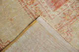 Hand-knotted foundation of vintage Oushak carpet, original side cord selvage, and textured pile.