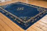 Vintage Peking carpet, central roundel medallion with delicate floral vinery on indigo blue.