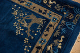 Vintage Peking rug's corner with playful pictorial border in indigo and beige.