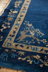 Vintage Peking carpet corner: indigo blue, beige, and sky blue pictorial floral branch motif.
