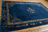 Chinese Peking rug corner: indigo blue field, beige pictorial border, deer, blossomed trees.