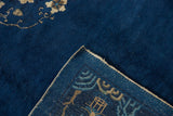 Detail of vintage Peking carpet, showing indigo pile, intact side cord selvage, and reverse weave.
