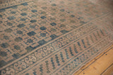Intact side selvage of the distressed Khotan carpet, showing soft texture and geometric field.