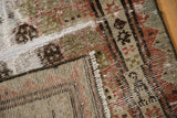 Distressed Malayer runner close-up, revealing worn copper, brown pile, exposed foundation, selvage.