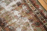 Distressed Malayer runner showing exposed foundation, copper boteh and zig-zag border.