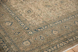 Distressed Sivas carpet corner displaying an indigo floral border and ivory vinery.