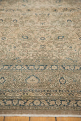 Distressed vintage Sivas carpet border featuring floral motifs and faded blue vinery.
