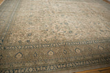 Vintage distressed Sivas carpet detail: curvilinear vinery field with indigo floral border.