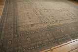 Vintage Distressed Sivas carpet corner displaying indigo vinery and floral motifs on a beige field.
