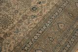 Distressed Sivas rug section: faded beige scrolling vinery and contrasting indigo floral border.