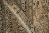 Textured vintage Sivas rug pile, revealing distressed antique ivory and indigo scrolling vinery.