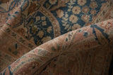 Distressed vintage Meshed rug detail, showing softened sky blue, blush, and coffee mil fleur.