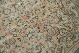 Persian Arak carpet detail: pale blush, ivory floral pattern with visible wear and foundation.
