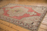 Evenly worn pile of vintage Oushak rug, showing blush field and beige border motifs.