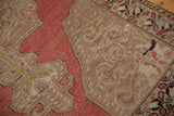 Vintage distressed Oushak rug: faded blush field meets beige border with leaf patterns.