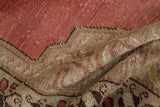 Heavily distressed pile reveals blush and ivory hues with faint foundation on folded Oushak.