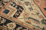 Antique Serapi carpet detail: navy border and light field with pale terra cotta geometric floral vinery.
