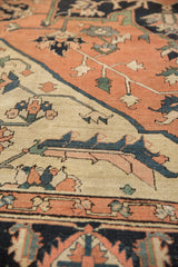 Hand-knotted antique Serapi carpet section with geometric floral vinery in pale terra cotta and navy.