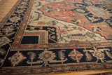 Antique Serapi carpet section showing geometric floral vinery in navy blue, terra cotta, and beige.