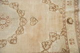 Distressed Oushak rug with abrashed field and coffee brown germinating plants.