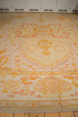 Antique Oushak rug with serrated lightening contour in pale lemon, terra cotta, and blush.