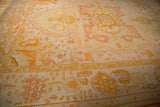 Antique Oushak carpet: unique wide border, serrated field pattern. Pale lemon, saffron, dusty rose.