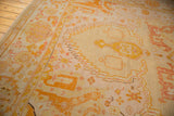 Hand-knotted Antique Oushak carpet field showing serrated lightning contour in pale lemon, gold, blush.