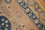 Distressed pale bronze field with navy roundel, floral guls, and tree of life motifs.