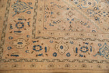 Vintage Mahal carpet's low pile, showing samovar border and sky blue Herati field motifs.