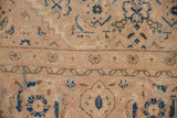 Worn pile of vintage Mahal carpet featuring beige ground, sky blue, and brown Herati motifs.