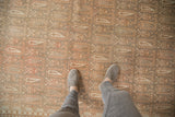 Distressed Sivas carpet showing allover plant and boteh pattern in time-softened hues.