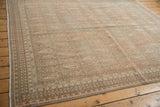 Distressed Sivas rug corner with traditional borders and softened, muted plant and boteh motifs.