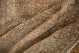 Decorative folded vintage Sivas carpet with repeating plant and boteh motifs in time-softened tones.