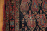 Vintage Senneh rug: red side selvage, patterned border, navy field with exposed knot heads.
