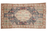 Vintage Distressed Sparta rug, beige medallion, dark denim blue field, mint green spandrels, red florals.