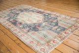 Faded distressed patterns in denim blue, mint green, and pale cherry red.