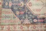 Vintage Distressed Sparta rug pattern in dark blue, mint green, and pale cherry florals.