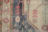 Distressed Vintage Sparta rug: faded dark denim blue, beige, cherry red, and mint floral detail.