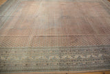 Distressed vintage Mir Sarouk rug showing allover boteh pattern, abrash, and detailed border.