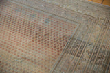 Abrashed beige, terra cotta, and blue tones highlight diminutive boteh and intricate Mir Sarouk borders.