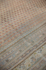 Distressed Mir Sarouk carpet: worn pile, abrashed boteh field, and detailed patterned borders.