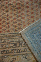 Blue hand-knotted foundation and distressed beige, terra cotta boteh pile of a Persian Mir Sarouk rug.