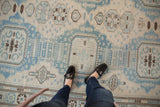 Powder blue and ivory Afghani Soumac rug with repeating geometric and minor medallions.